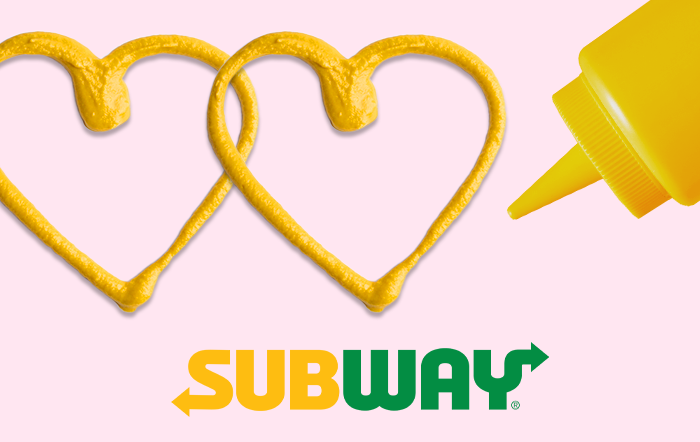 Light pink gift card with the subway logo and a mustard container drawing hearts in mustard.