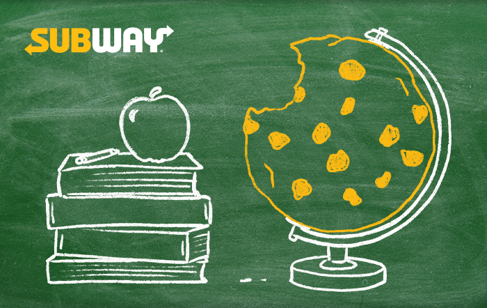 Gift card with a green chalkboard background. On it is the subway logo, and a chalk drawing of a stack of books and and apple next to a globe where the earth has been replaced with a large cookie.