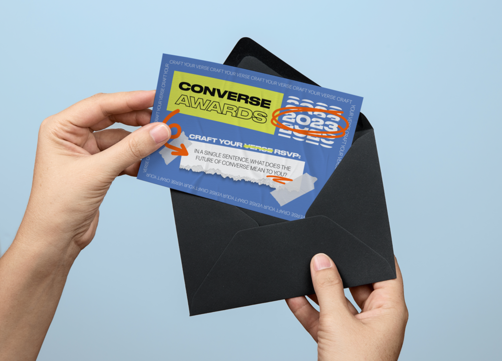 Photo of hands pulling a card out of a black envelope. The card reads, "Converse awards 2023. Craft your verse / rsvp: in a single sentence, what does the future of converse mean to you?" The card is designed to look annotated / drawn on and taped together.