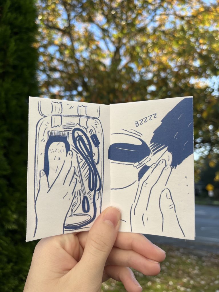 Photos of an 8 page zine held up against a blurry outdoor background. Drawings are in dark blue on a white background. Panel 2: Close-up of a hand reaching for clippers in a container with guards in scissors. Panel 3: Close-up of the hand bringing the clippers up to the side of a head of dark hair.